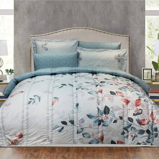 Blue and white comforter set with floral designs, matching pillow shams, and a beige upholstered headboard in a stylish bedroom