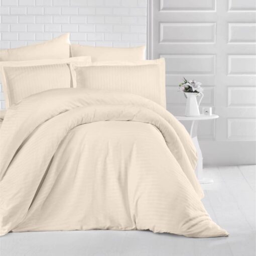 queen bed with beige stripe bed sheet and comforter on the bed adding a nice touch to the white room, stripe bed sheets and comforter set with four pillows