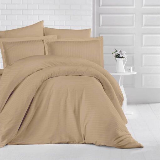 queen bed with light brown stripe bed sheet and comforter on the bed adding a nice touch to the white room, stripe bed sheets and comforter set with four pillows