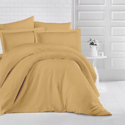 queen bed with orange stripe bed sheet and comforter on the bed adding a nice touch to the white room, stripe bed sheets and comforter set with four pillows