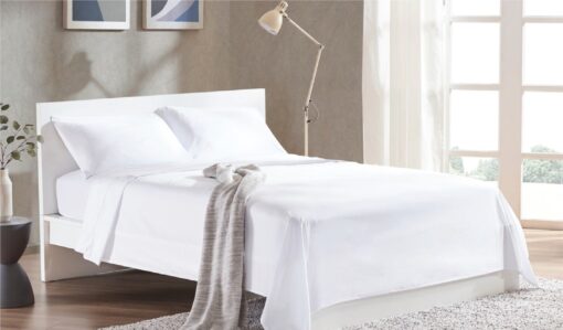 bed sheet white color spread on queen size bed, in nice decorated room, tow pillow on the bed