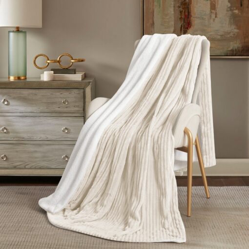 Throw Blanket Masterpiece Reem, beige color, soft touch , on a chair in a nice decorated room, Crafted from luxurious velvet, king, queen, single sizes, the Reem pattern design, combining classic elegance with contemporary flair, 200*230CM